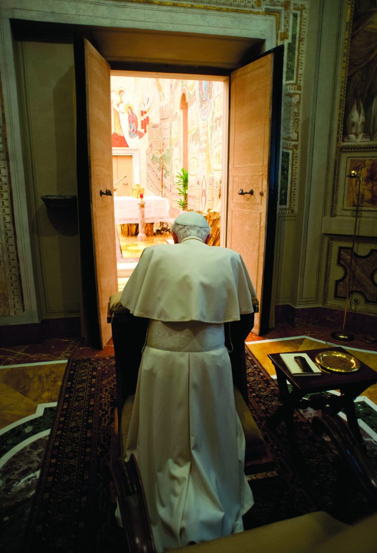 In this photo provided by the Vatican newspaper L'Osservatore Romano, Pope Benedict XVI kneels in prayer at the end of a weeklong spiritual retreat, at the Vatican, Saturday, Feb. 23, 2013. Benedict XVI has lamented the 