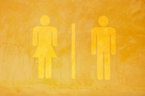 Toilet sign on cement wall