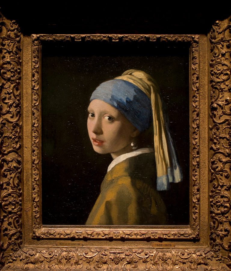 This reproduction shows Johannes Vermeer's Girl with a Pearl Earring (painted approximatetely 1665) at the renovated Mauritshuis museum during a preview for the press in The Hague, Netherlands, Friday, June 20, 2014. The Mauritshuis reopens after a two-year renovation that allowed its masterpieces, including Vermeer's The Girl with the Pearl Earring to be seen by record-setting crowds abroad. The public will have access for free from 8 pm till midnight on Friday June 27th after the official ceremonial opening and from June 28 onwards the museum will revert to regular opening hours. (AP Photo/Peter Dejong)