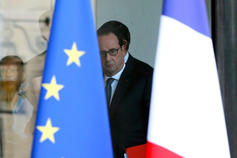 French President Francois Hollande is seen through the glass door after a security meeting at the Elysee palace in Paris, France, Saturday, Nov. 14, 2015. French President Francois Hollande vowed to attack the Islamic State group without mercy as the jihadist group admitted responsibility Saturday for orchestrating the deadliest attacks inflicted on France since World War II. (AP Photo/Jacques Brinon)