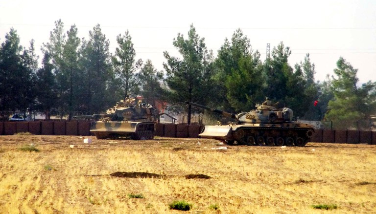 Turkey's military launched an operation before dawn Wednesday to clear a Syrian border town from Islamic State militants, and a private Turkish TV station reported that a small number of Turkish special forces crossed into Syria as part of the operation. (DHA via AP)