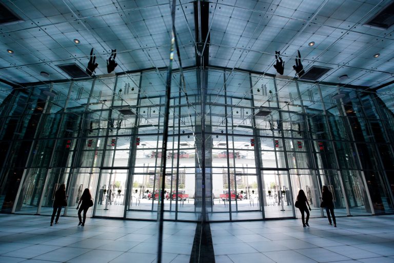 In this photo taken on Aug. 20, 2014, people, reflected in mirrors, walk out of the front entrance of the SLS Las Vegas in Las Vegas. The hotel and casino, formally known as the Sahara, has gone through extensive renovations is scheduled to open this weekend. (AP Photo/John Locher)