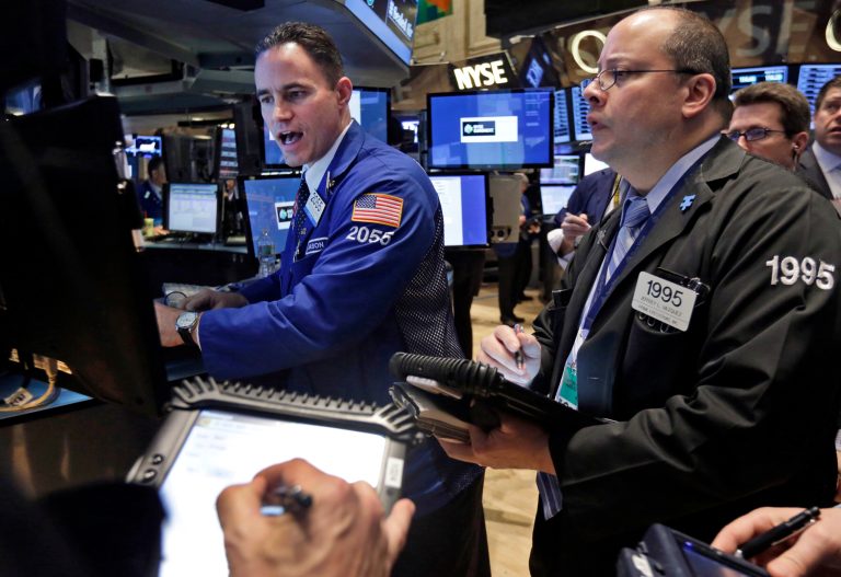 FILE - In this Tuesday, April 8, 2014 file photo, specialist Jason Hardzewicz, left, works at his post on the floor of the New York Stock Exchange. A solid start to the U.S. quarterly corporate reporting season helped shore up the mood across financial markets on Wednesday, ahead of the minutes to the last policy meeting of the U.S. Federal Reserve. (AP Photo/Richard Drew, File)