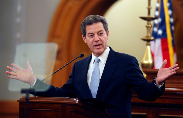 Kansas Gov. Sam Brownback delivers his State of the State speech to an annual joint session of the House and Senate at the Statehouse in Topeka, Kan., Wednesday. (AP Photo/Orlin Wagner)
