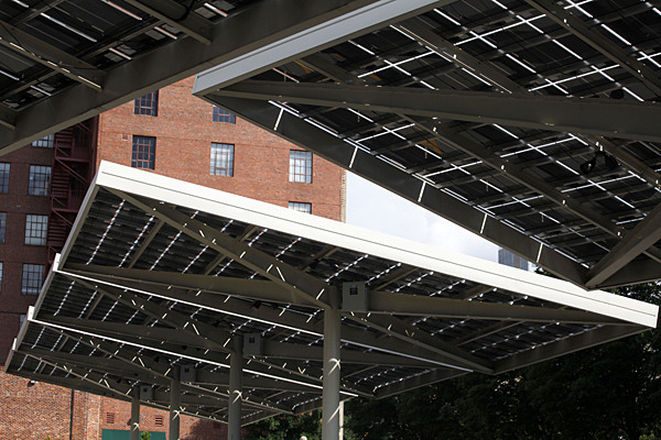 Solar panels cover cars parked in a lot nearby Centennial Olympic Park, Tuesday, July 2, 2013, in Atlanta. The Georgia chapter of Americans For Prosperity, founded by billionaire brothers Charles and David Koch, wants Georgia's utility regulators to reject a solar energy plan in Georgia. But an Associated Press review ahead of a vote on the issue finds that it has used misleading figures to build its case. (AP Photo/Jaime Henry-White)