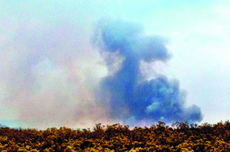 Black smoke rises from over a ridge near Stanley Road and Checkmate Rd as the Buck fire continues to burn, Wednesday, August 15, 2012, near Hemet, Calif. Across the West, dozens of fires fueled by searing heat, dry weather and strong winds have added up to misery for weary residents who already are fed up with one of the region's worst fire seasons in decades. (AP Photo/The Desert Sun, Crystal Chatham) RIVERSIDE PRESS-ENTERPRISE OUT; NO SALES; NO FOREIGN