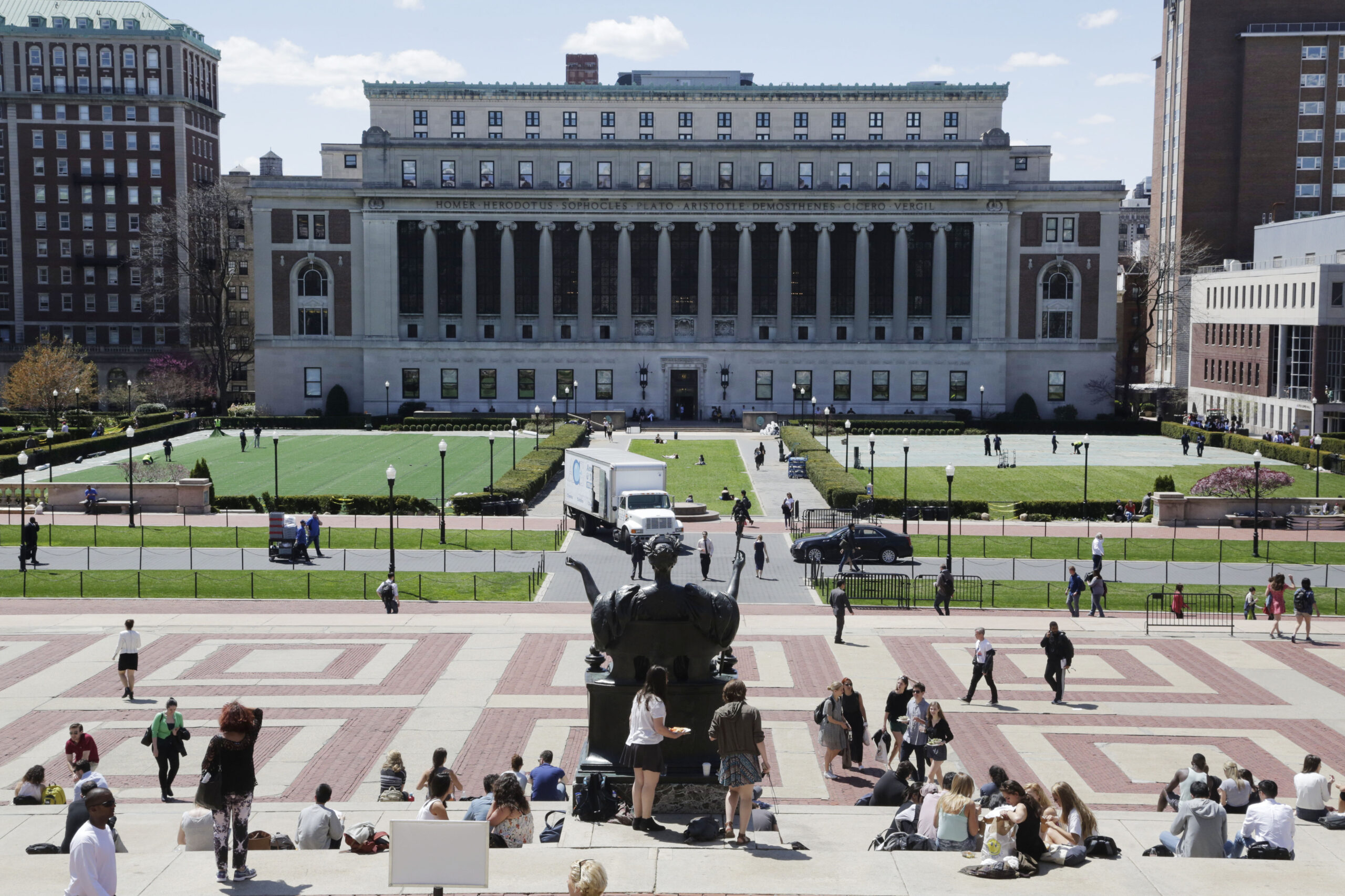 Columbia mattress girl carries her bed on stage at graduation