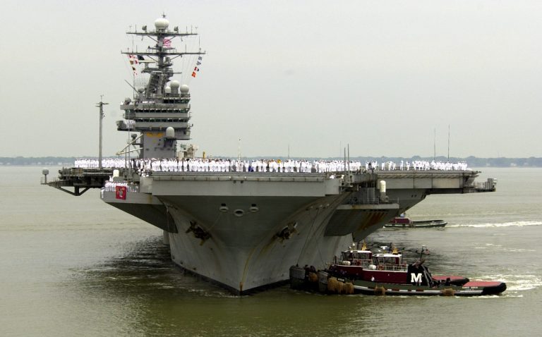 Sailors man the rails as the USS Theodore Roosevelt is manuvered into it's berth at the Norfolk Naval Station in Norfolk, Va. U.S. Navy officials say the aircraft carrier USS Theodore Roosevelt is steaming toward the waters off Yemen and will join other American ships prepared to intercept any Iranian vessels carrying weapons to the rebels fighting in Yemen. (AP Photo/Steve Helber)