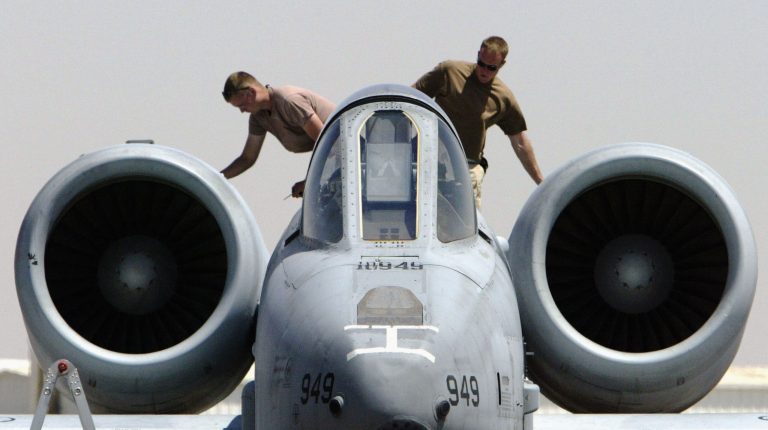 U.S. Airforce ground maintainence crewmen check over the engines of an A10 Thunderbolt 'Warthog' after it had returned from a mission April 2, 2003, at an air base near the Iraqi border. (Photo by Ian Waldie/Getty Images)