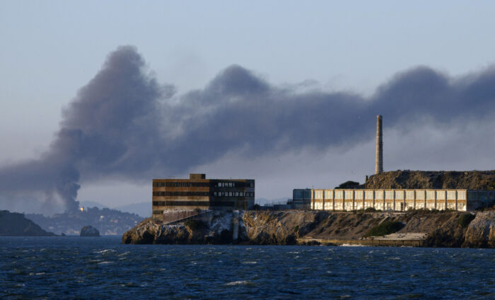 This Aug. 6, 2012, file photo shows smoke pouring from a fire at the Chevron Richmond Refinery behind Alcatraz Island in San Francisco.