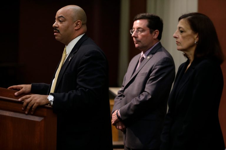 Philadelphia District Attorney Seth Williams, left, accompanied by 1st Assistant District Attorney Ed McCann, center, and Assistant District Attorney Joanne Pescatore, speaks during a news conference, Wednesday, May 22, 2013, in Philadelphia. Williams announced Herbert and Catherine Schaible who believe in faith healing over medicine have been charged with murder after a second child died of pneumonia. (AP Photo/Matt Rourke)