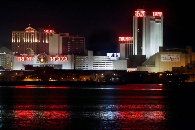 FILE - In a Tuesday, Sept. 2, 2014 file photo, The Trump Plaza Hotel Casino is illuminated at night in Atlantic City, N.J. A Delaware bankruptcy judge on Wednesday, Sept. 10, 2014, agreed to allow Trump Entertainment Resorts to temporarily continue operations using cash owed to billionaire Carl Icahn, the company's sole secured lender. Judge Kevin Gross also signed routine orders allowing the company, which owns two Atlantic City casinos, to continue paying vendors and employees as it works on a debt restructuring that could avert the closing of the Taj Mahal Casino Resort. The company, whose Trump Plaza resort is closing in a week, sought bankruptcy protection on Tuesday. (AP Photo/Mel Evans, File)