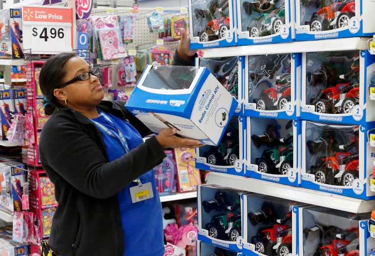 FILE - In this Nov. 26, 2013 file photo, toy department manager Gayla Harris stocks shelves for Black Friday sales at a Wal-Mart store in Oklahoma City. Wal-Mart Stores Inc. says it plans to hire 60,000 temporary holiday workers for the crucial holiday season in 2014, an increase of nearly 10 percent from last year. (AP Photo/Sue Ogrocki, File)