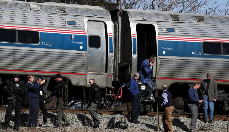 Passengers watch as emergency personnel operate work at the scene of a train crash involving a garbage truck in Crozet, Va., on Wednesday. An Amtrak passenger train carrying dozens of GOP lawmakers to a Republican retreat in West Virginia struck a garbage truck south of Charlottesville, Va. No lawmakers were believed injured. (Zack Wajsgrasu/The Daily Progress via AP)