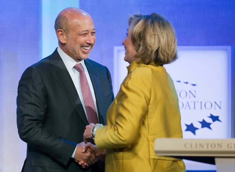 Lloyd Blankfein, left, chairman and CEO of Goldman Sachs, is greeted by Hillary Clinton for a panel discussion at the Clinton Global Initiative, Sept. 24, 2014 in New York. (AP Photo/Mark Lennihan)