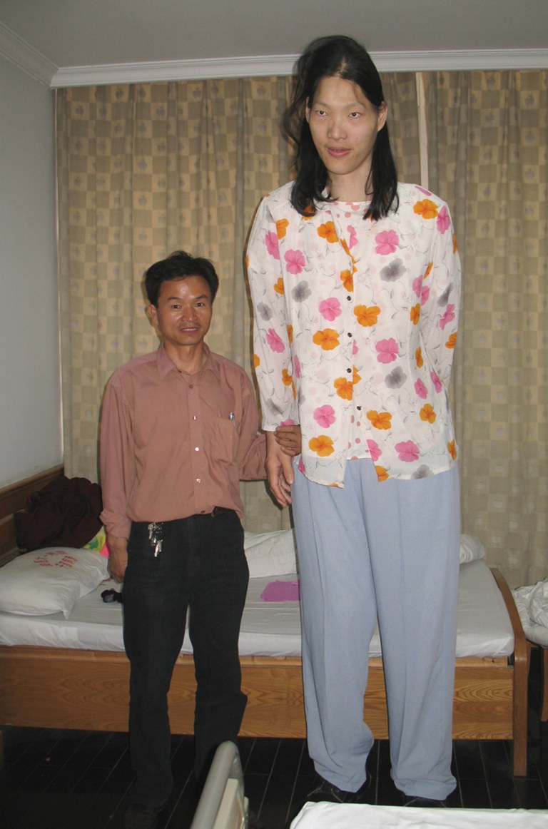   FILE - In this May 12, 2006 file photo released by China's Xinhua News Agency, Yao Defen, right, who is 7 feet and 7 inches (233.3 centimeters) tall poses for a photo with her elder brother in a hospital affiliated to Anhui Medical University where she is having a physical examination, in Hefei, the capital of east China's Anhui Province. The worldâs tallest woman has died in eastern China. She was 39. Chinese state media say Yao died on Nov. 11, 2012, at her home in Chinaâs eastern province of Anhui. (AP Photo / Xinhua, Wang Shilong, File) NO SALES  