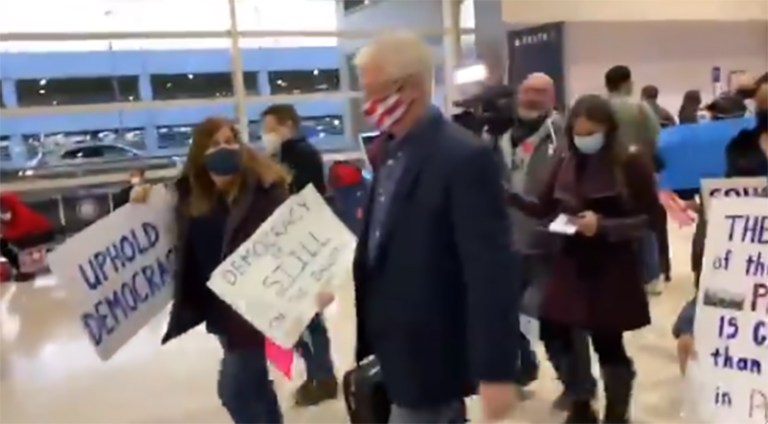 Activists hound Michigan Senate majority leader at airport en route to meet with Trump