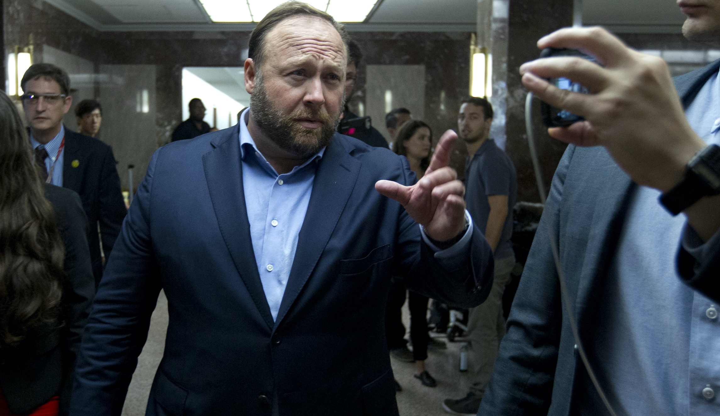 Alex Jones delays new podcast, accused of trying to squirm out of paying Sandy Hook families