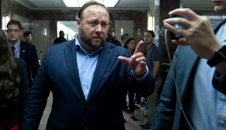 Radio host Alex Jones walks on the corridors of Capitol Hill after listen Facebook COO Sheryl Sandberg and Twitter CEO Jack Dorsey hearing before the Senate Intelligence Committee on 'Foreign Influence Operations and Their Use of Social Media Platforms' on Capitol Hill, Wednesday, Sept. 5, 2018, in Washington.