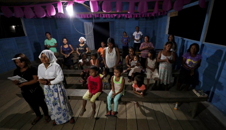 Worshippers attend a prayer ceremony known as the "celebration of the word" led by Antelmo Pereira at the Catholic church in Santa Rosa, Brazil, Saturday, Sept. 21, 2019.