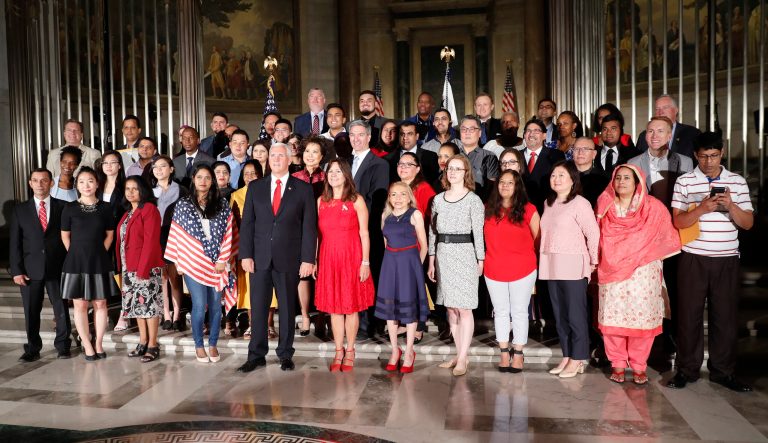 Vice President Mike Pence, center, his wife Karen Pence, pose for a group photo with new naturalized citizens following a naturalization ceremony in celebration of Independence Day.