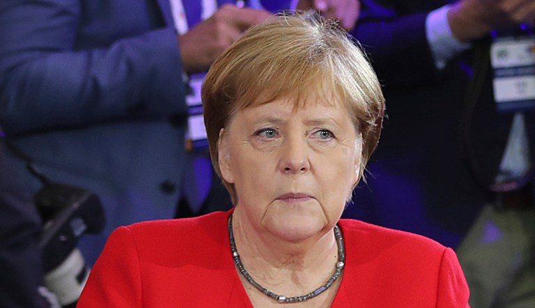 German Chancellor Angela Merkel,right, and Poland's Prime Minister Mateusz Morawiecki listening to a speech by Poland's President Andrzej Duda during a summit.