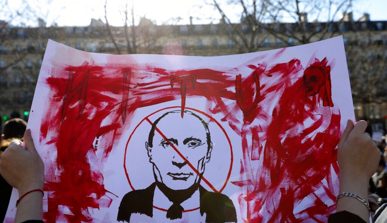 A demonstrator holds a poster show Russian President Vladimir Putin during a rally in protest against Russia's invasion of Ukraine, Saturday, Feb. 26, 2022 in Paris. From Tokyo to London to Taipei, Ukrainians living abroad and hundreds of protesters have turned out on the streets to join anti-war rallies spreading around the world as Russia's troops pressed toward Ukraine's capital.