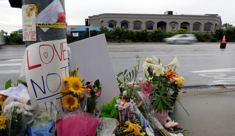 Signs of support and flowers adorn a post in front of the Chabad of Poway synagogue, Monday, April 29, 2019, in Poway, Calif. A man opened fire Saturday, April 27 inside the synagogue near San Diego, as worshippers celebrated the last day of a major Jewish holiday.