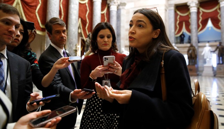 Rep. Alexandria Ocasio-Cortez, D-N.Y., speaks with reporters, Wednesday, Dec. 18, 2019, on Capitol Hill in Washington. President Donald Trump is on the cusp of being impeached by the House, with a historic debate set Wednesday on charges that he abused his power and obstructed Congress ahead of votes that will leave a defining mark on his tenure at the White House.