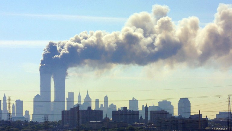 As seen from the New Jersey Turnpike near Kearny, N.J., smoke billows from the twin towers of the World Trade Center in New York.