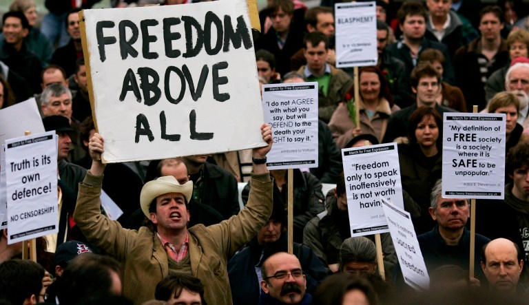 Protesters display banners at a demonstration rally supporting freedom of expression in London. 
