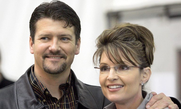 This Oct. 21, 2006 photo shows Sarah Palin standing beside her husband, Todd Palin, in Anchorage, Alaska. 