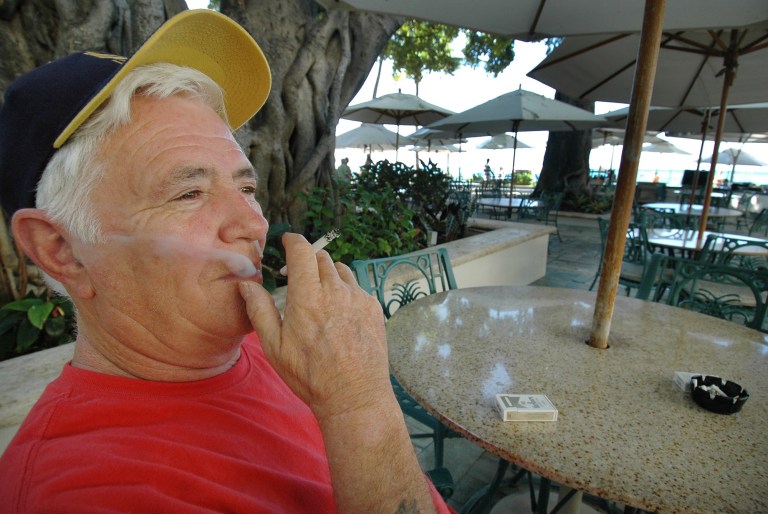 Tom Hansen, from Canada, smokes a cigarette at the  Sheraton Moana Surfrider, in Waikiki, Hawaii, Nov. 14, 2006.
