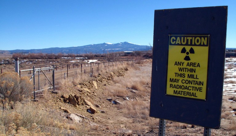 A warning sign at the old Kerr-McGee uranium mill site is shown on open land in the foreground with Mount Taylor in the background, Dec. 20, 2007 near Grants, N.M. Uranium mining could experience a resurgence in the area, with several mining companies conducting exploratory drilling in the Grants area. 