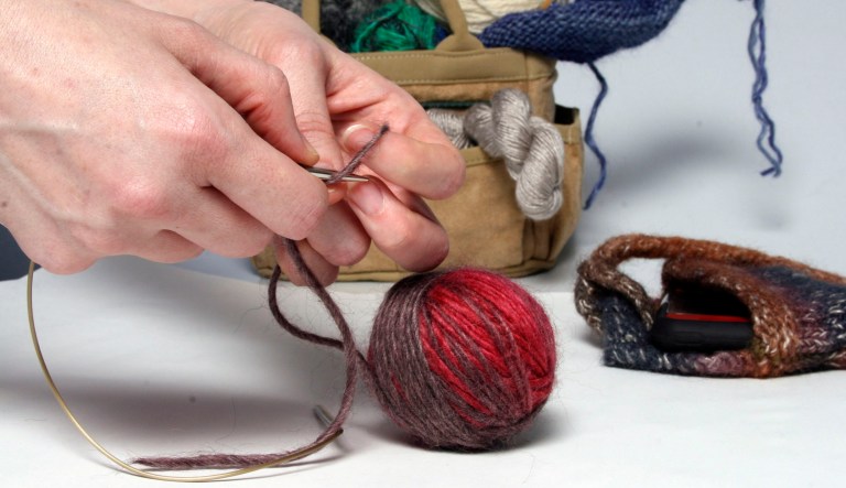 A person knits something out of yarn.