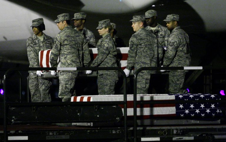 A carry team at Dover Air Force Base, Del., carries one of the transfer cases containing the remains of one of five fallen soldiers on Sunday, April 12, 2009.  Staff Sgt. Gary L. Woods Jr., 24, of Lebanon Junction, Ky.; Staff Sgt. Bryan E. Hall, 25, of Elk Grove, Calif.; Sgt. Edward W. Forrest Jr., 25, of St. Louis; Cpl. Jason G. Pautsch, 20, of Davenport, Iowa; and Private Second Class Bryce E. Gautier, 22, of Cypress, Calif. died April 10, 2009 when their military vehicle was struck by a suicide vehicle-borne improvised explosive device in Mosul, Iraq.  (AP Photo/Carolyn Kaster)