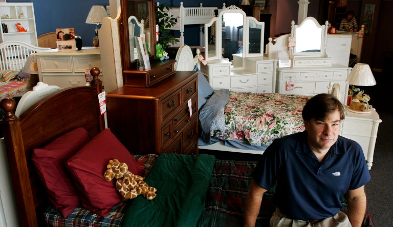 Michael Kaplan sits in his family's Palisade Furniture on Sept. 16, 2009 in Englewood, N.J. Kaplan went back to the family business after he lost his Wall Street job.