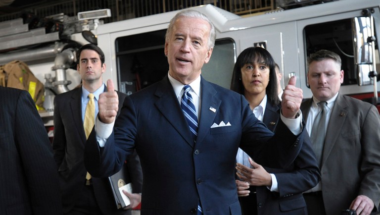 Vice President Joe Biden gestures to firefighters at East Hartford fire headquarters.