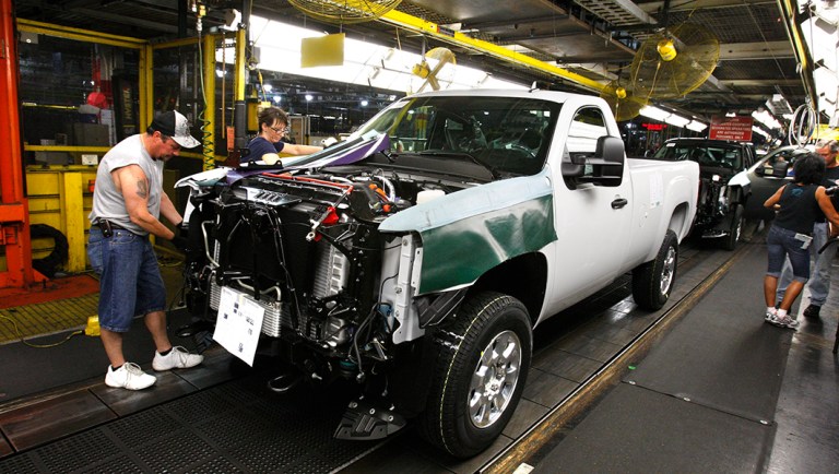 Kenny Bradburn works on the right front fender on the 2011 GMC Sierra at the Flint Assembly in Flint, Mich.