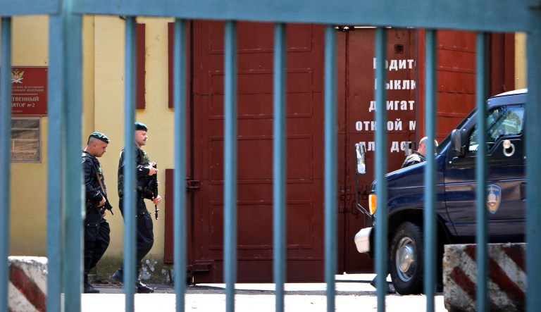 Officers of Russia's Federal Service for the Execution of Penal Sentences (FSIN) special forces walk near an armored vehicle before leaving Moscow's Lefortovo prison.