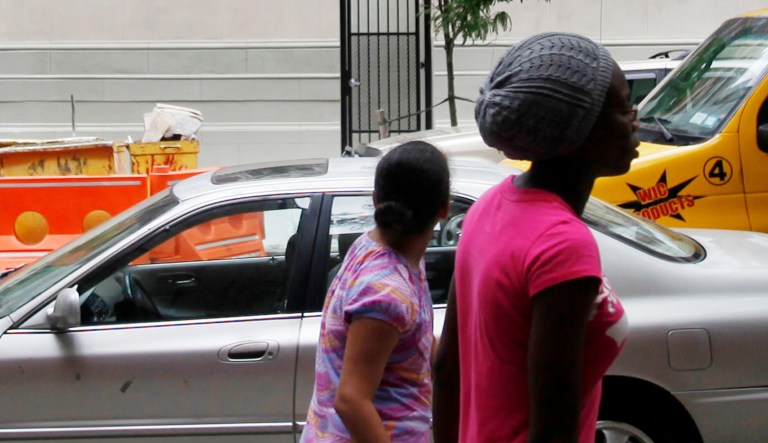 Youngsters walk near PS90 Condominiums, a $40 million conversion of a century-old public school on 147th Street in Harlem, N.Y.