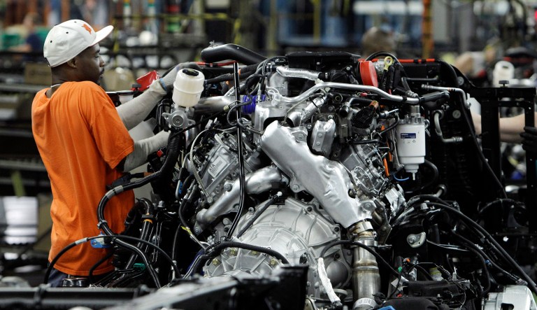 Line worker Randee Boose assembles a Chevrolet Silverado a pickup truck at the General Motors Flint Assembly plant in Flint, Michigan.