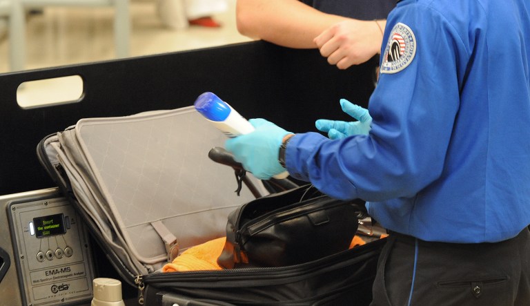 In this Aug. 3, 2011 photo, a Transportation Security Administration officer discovers unallowable liquids in a passenger's carry on luggage at the security checkpoint at Hartsfield-Jackson Atlanta International Airport, in Atlanta. The TSA was created after the terrorist attacks of Sept. 11, 2001.