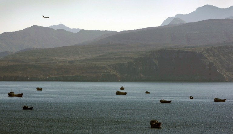 In this Jan. 19, 2012, photo, a plane flies over the mountains neighboring the Strait of Hormuz.