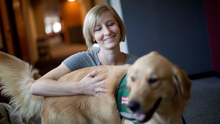 Law student Amelia Myers, 25, plays with Hooch, a 19-month-old golden retriever, between final exams at Emory University in Atlanta.