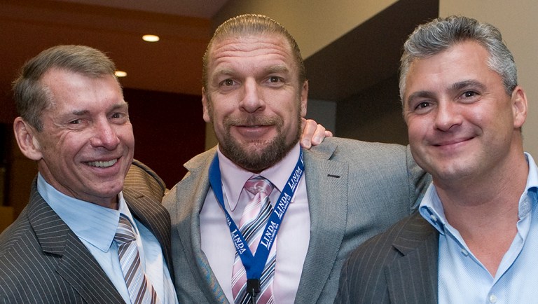 Vince McMahon, left, poses for a photo with son-in-law Paul Levesque as known as the wrestler Triple H and son Shane McMahon, right.