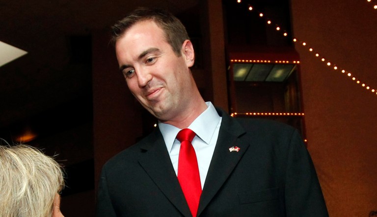 FILE - In this June 12, 2012 photo, Republican Congressional candidate Jesse Kelly shakes hands with a supporter at a post election event prior to election results  in Tucson, Ariz.  Kelly on Thursday, June 14, 2012,  dropped out of the race for Gabrielle Giffords' former seat in Congress, two days after losing a special election to serve out her term. Kelly said in a statement that he decided to withdraw after "looking at the results from Tuesday." He lost the special election to Rob Barber, a former Giffords' staffer and fellow mass shooting survivor.