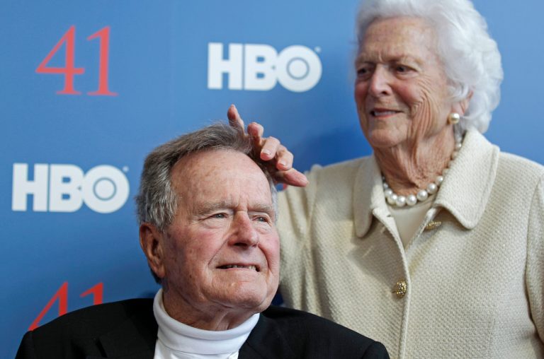 Former first lady Barbara Bush touches the hair of her husband President George H.W. Bush as they arrive for the premiere of HBO's new documentary on his life, near the family compound in Kennebunkport, Maine, June 12, 2012.