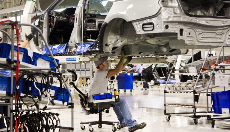 FILE - In this July 31, 2012, file photo, an employee works on a Passat sedan at the Volkswagen plant in Chattanooga, Tenn.  Lured by low wages and tax-saving free trade agreements, auto companies from the U.S. and overseas are accelerating plans to build new factories and add jobs in Mexico. The moves, part of a decade-long trend, are luring investments and work that could have gone to the U.S. and Canada, according to experts. But they also are likely to keep car and truck prices in check even as automakers add expensive fuel-saving features to meet U.S. gas mileage requirements. 