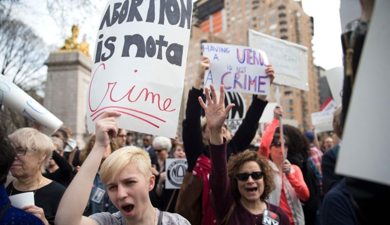 Kayla Forshey, left, participates in a rally to condemn Republican presidential candidate Donald Trump's remarks about women and abortion Thursday, March 31, 2016, in New York. 